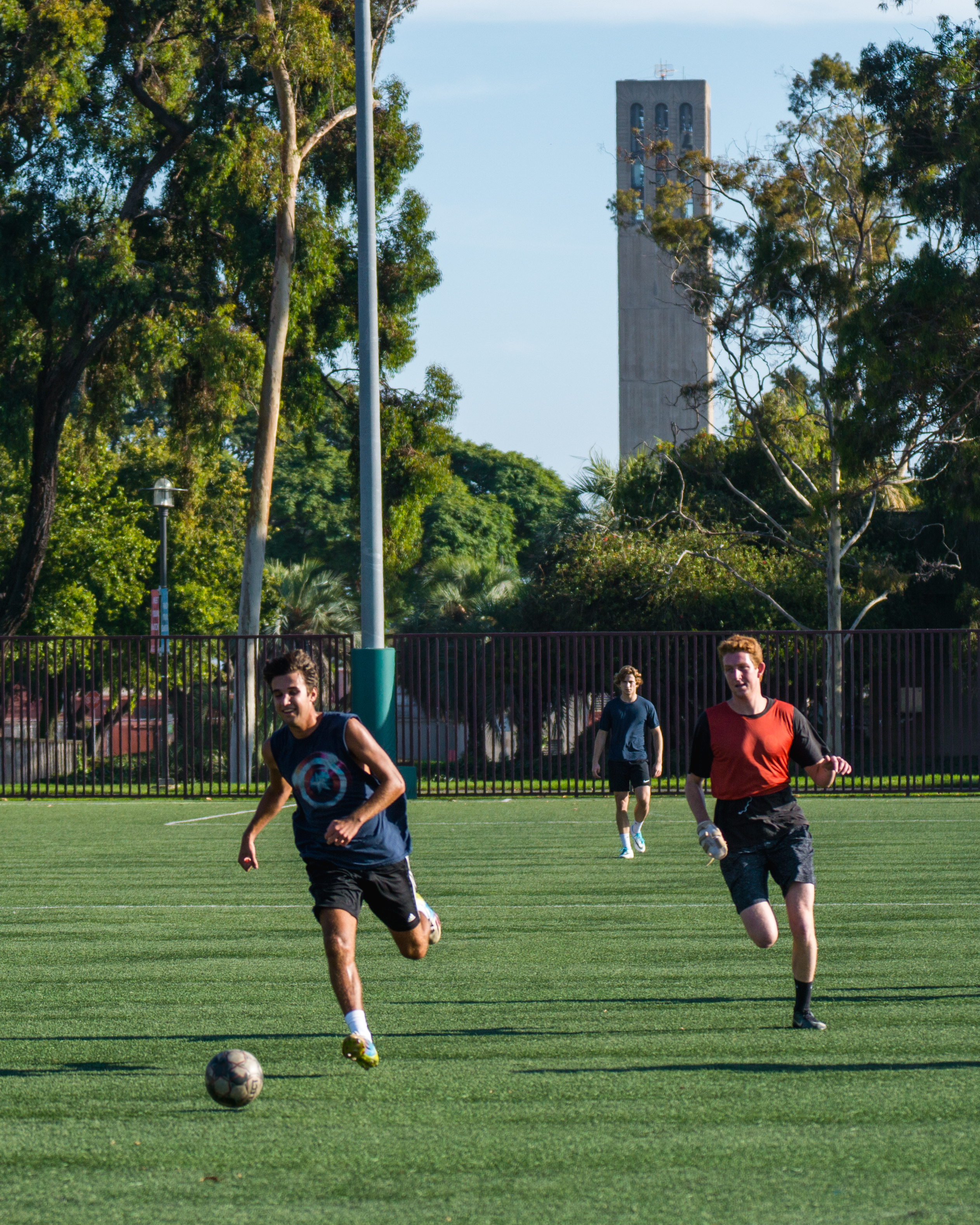 UCSB Students playing soccer at the Rec Cen fields with Storke Tower in the background.